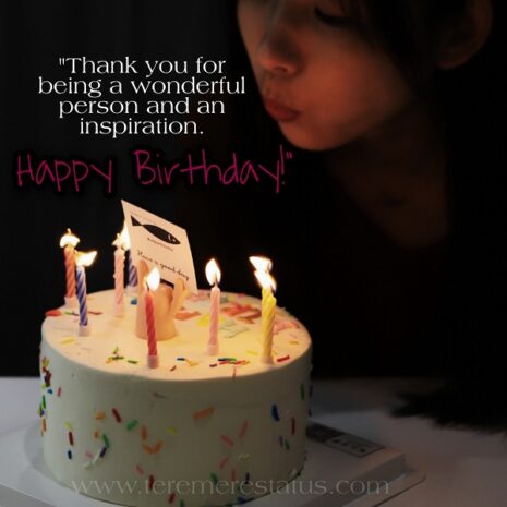 a girl is in the dark background is blowing birthday candles